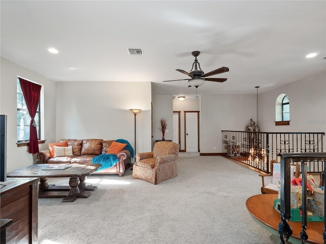 living room featuring carpet flooring and ceiling fan