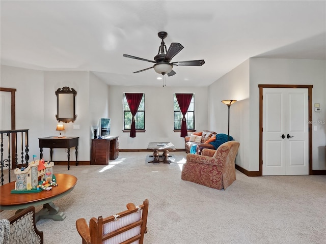 carpeted living room featuring ceiling fan