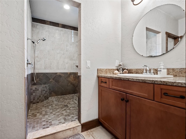 bathroom featuring vanity and a tile shower