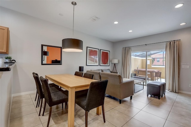 dining area featuring light tile floors