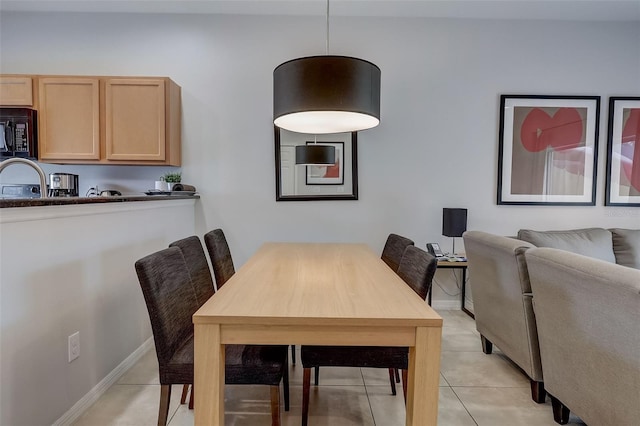 dining area featuring light tile flooring