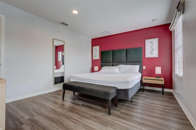 bedroom with hardwood / wood-style flooring