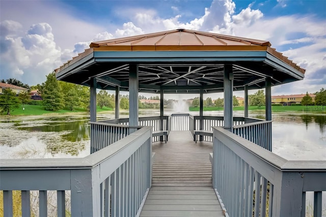 view of dock with a gazebo and a water view