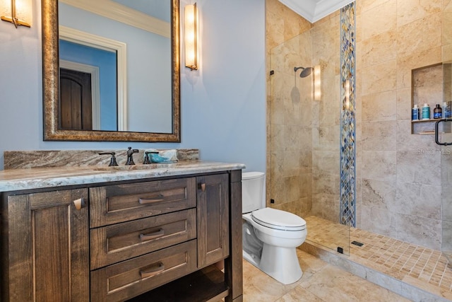 bathroom with ornamental molding, vanity, tile flooring, and tiled shower