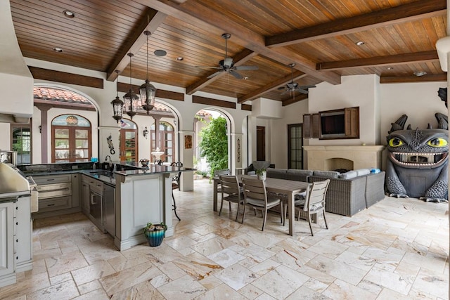 kitchen featuring ceiling fan, wooden ceiling, pendant lighting, and light tile floors