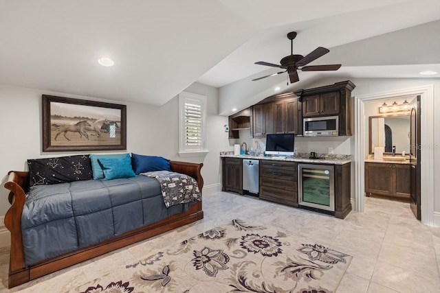 tiled bedroom featuring sink, ceiling fan, ensuite bathroom, vaulted ceiling, and beverage cooler