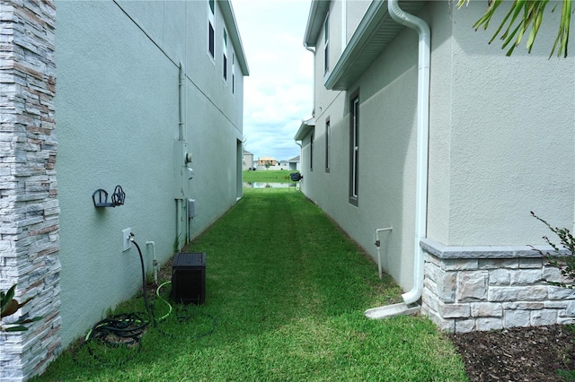 view of side of property with a lawn