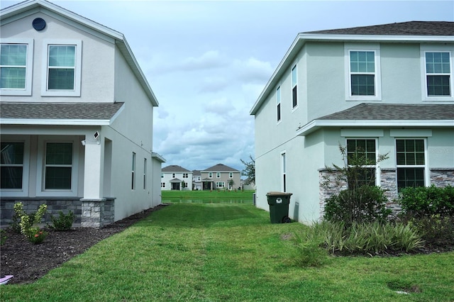 view of side of home featuring a lawn