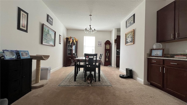 carpeted dining space with a notable chandelier and a textured ceiling