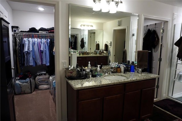 bathroom featuring vanity and a notable chandelier