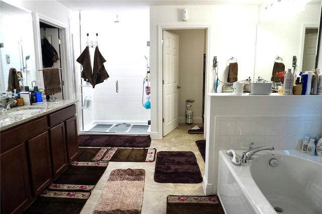 bathroom with tile flooring, a bathing tub, and vanity