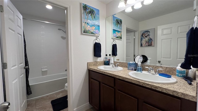 full bathroom with toilet, washtub / shower combination, double sink, vanity with extensive cabinet space, and tile floors