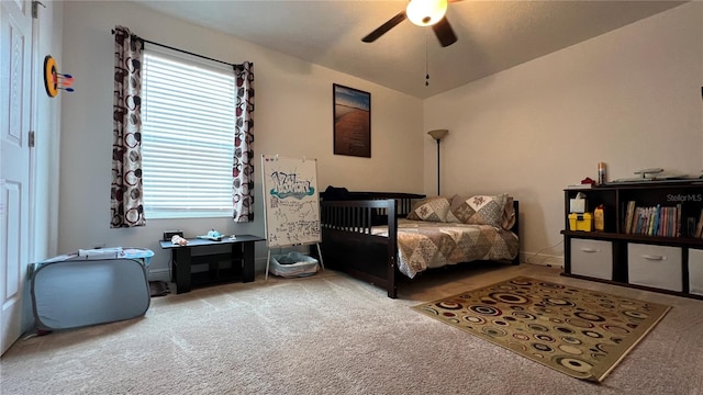 carpeted bedroom with vaulted ceiling and ceiling fan