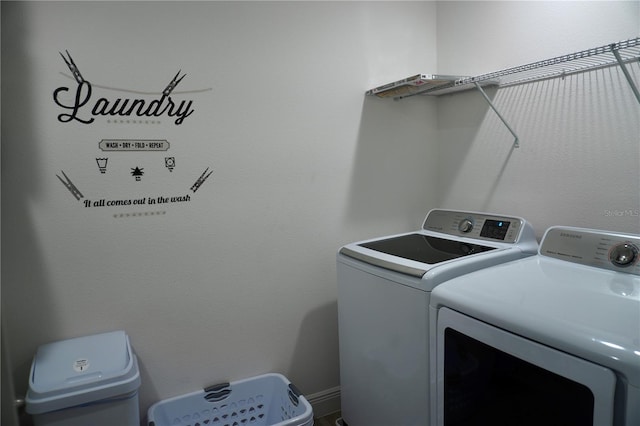 clothes washing area featuring separate washer and dryer