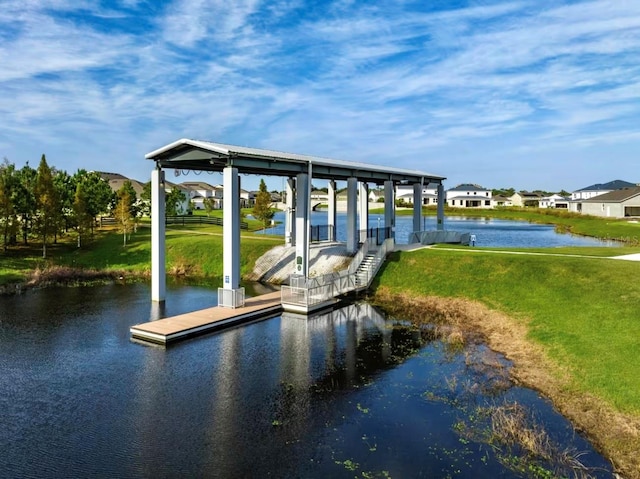 dock area featuring a water view and a yard