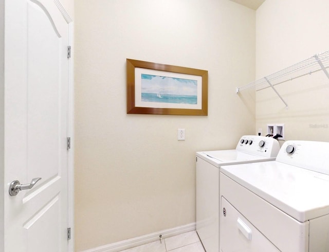 clothes washing area with washing machine and dryer, light tile flooring, and hookup for a washing machine