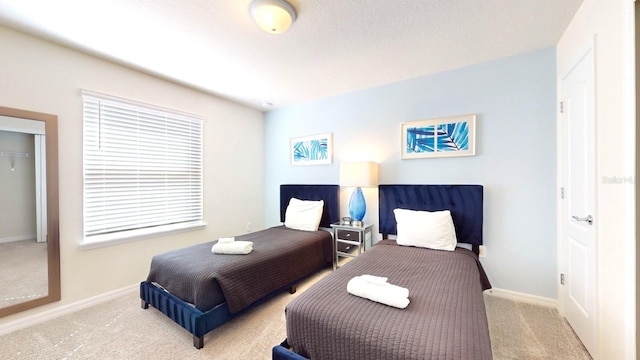 bedroom featuring light carpet and a closet