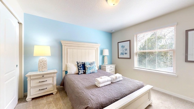 carpeted bedroom with a closet