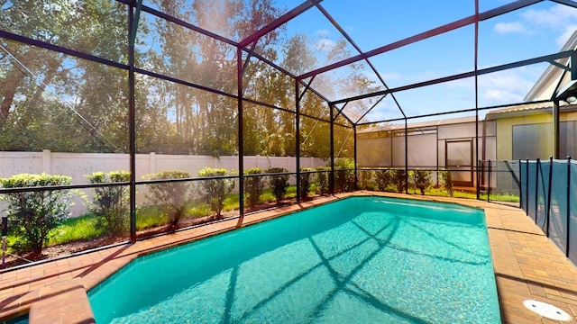 view of pool featuring glass enclosure