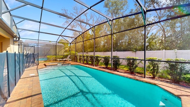 view of pool featuring an in ground hot tub and a lanai