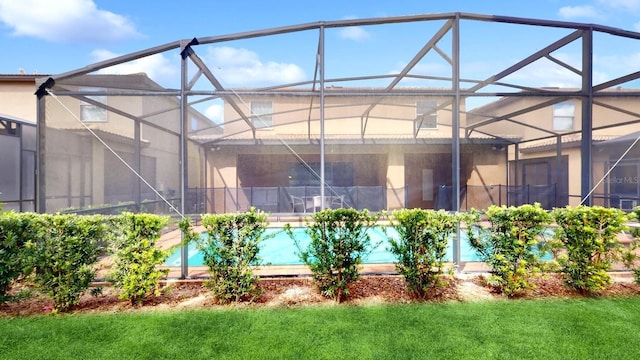 view of swimming pool featuring glass enclosure