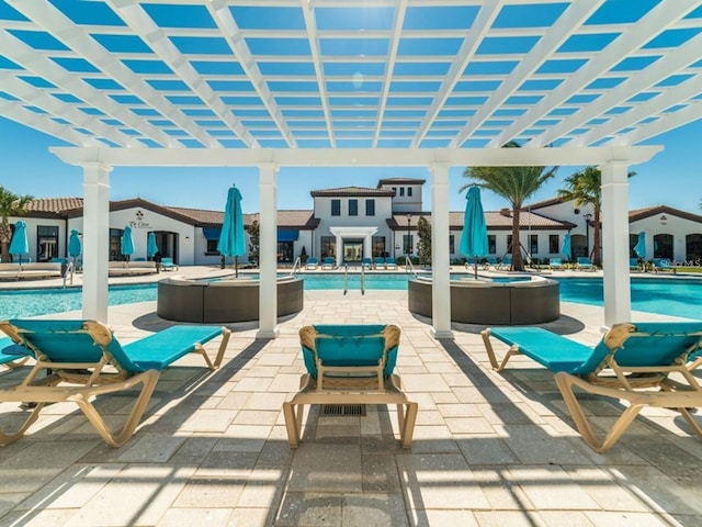 view of patio / terrace with a pergola and a community pool