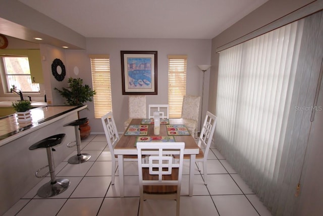 dining area featuring light tile floors