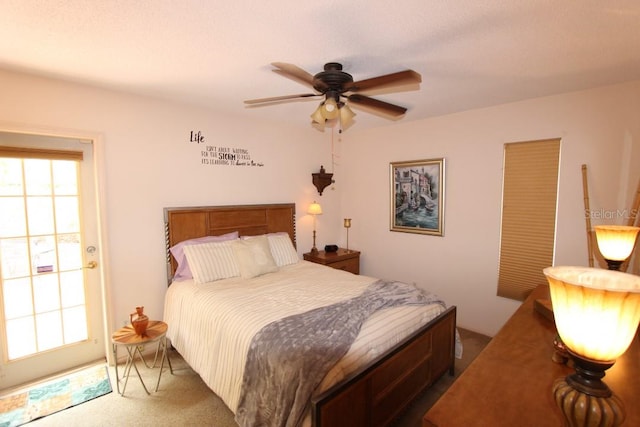 bedroom featuring carpet flooring, ceiling fan, and multiple windows