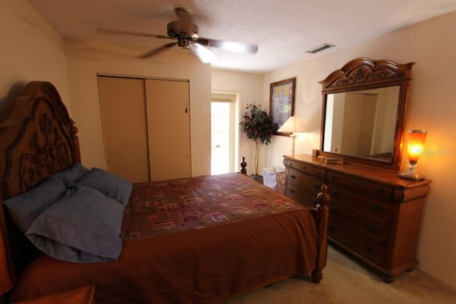 bedroom with a closet, light carpet, and ceiling fan