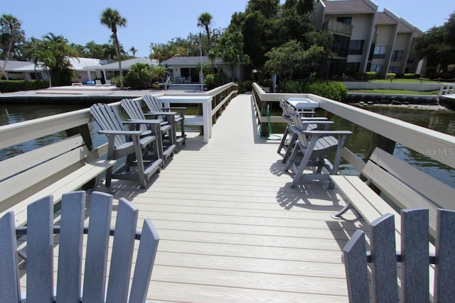 exterior space with a water view and a boat dock