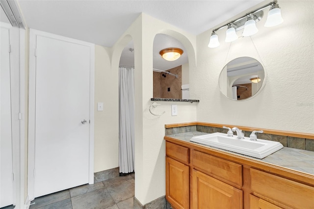 bathroom with large vanity and tile flooring