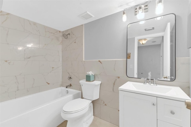 full bathroom with vanity, tile walls, tile floors, tiled shower / bath, and toilet