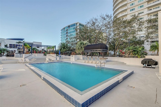 view of swimming pool with a patio area and a grill