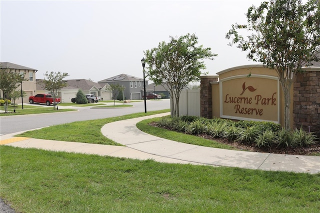 community / neighborhood sign with a yard