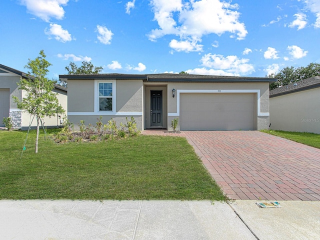 ranch-style house with a front yard and a garage