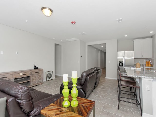 tiled living room featuring sink