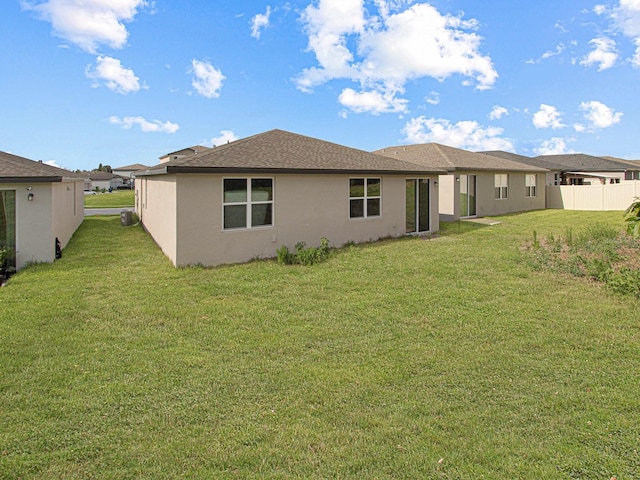 back of house with a lawn