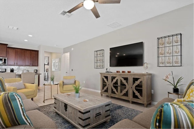 living room with tile patterned floors and ceiling fan