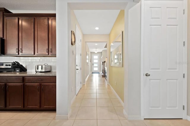 hall featuring light tile patterned flooring