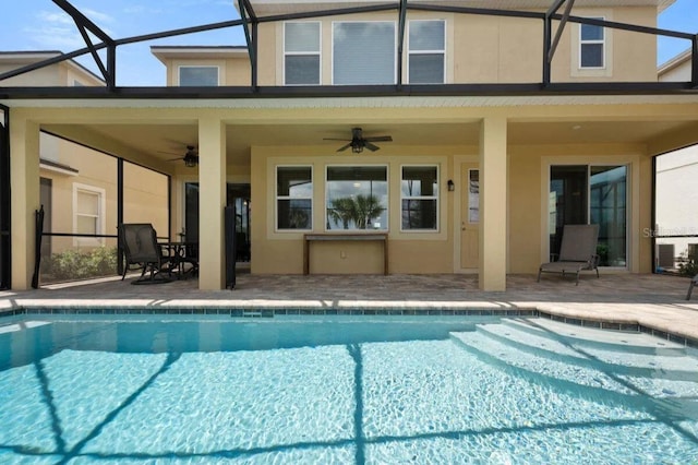 view of pool with a lanai, a patio area, and ceiling fan