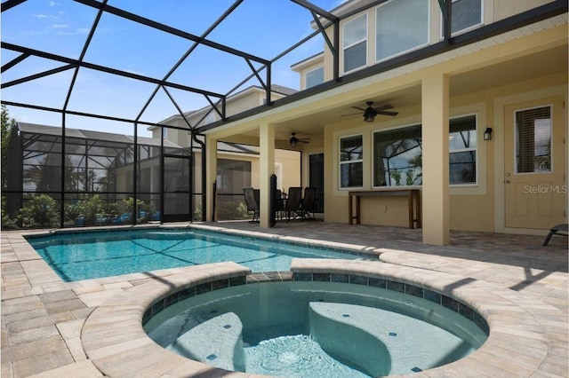 view of pool with a lanai, a patio area, an in ground hot tub, and ceiling fan