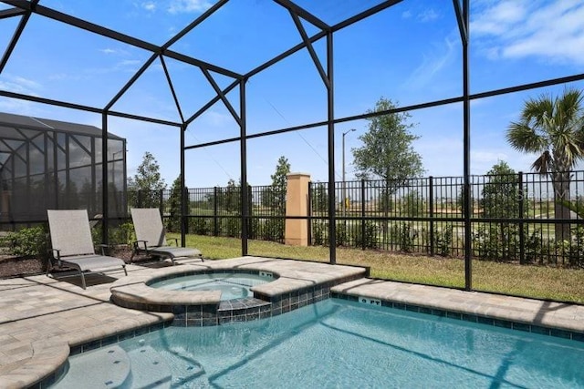 view of pool featuring an in ground hot tub and glass enclosure