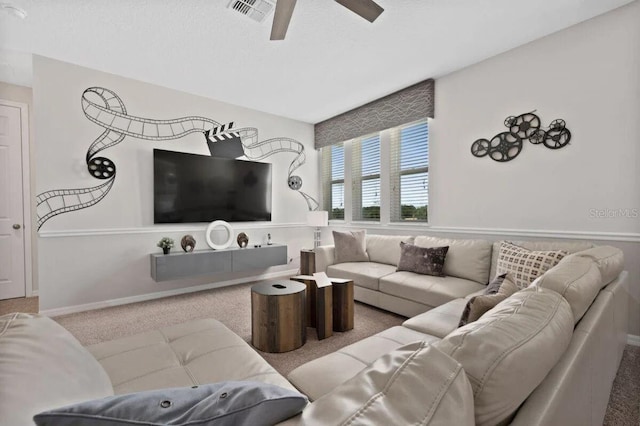 carpeted living room with ceiling fan