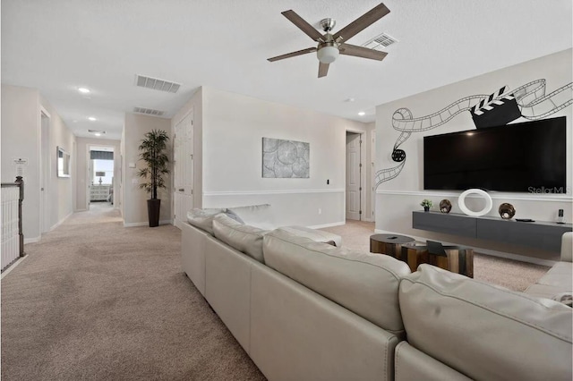 living room featuring ceiling fan and light colored carpet