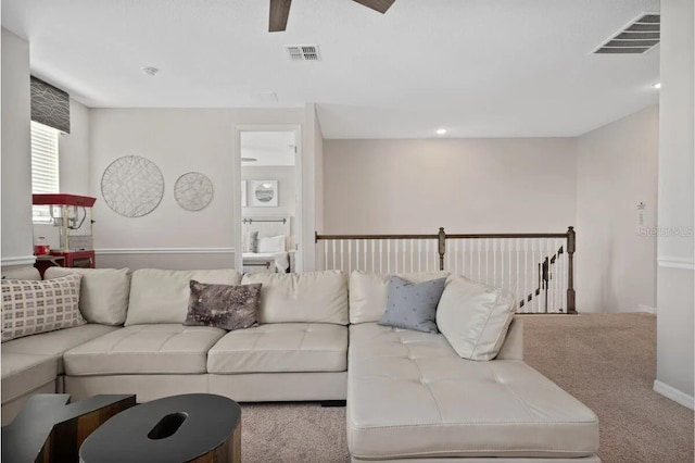 living room with ceiling fan and carpet flooring