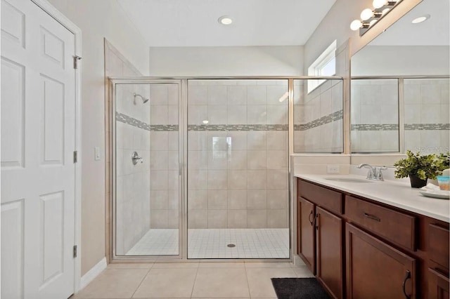 bathroom featuring vanity, tile patterned flooring, and walk in shower