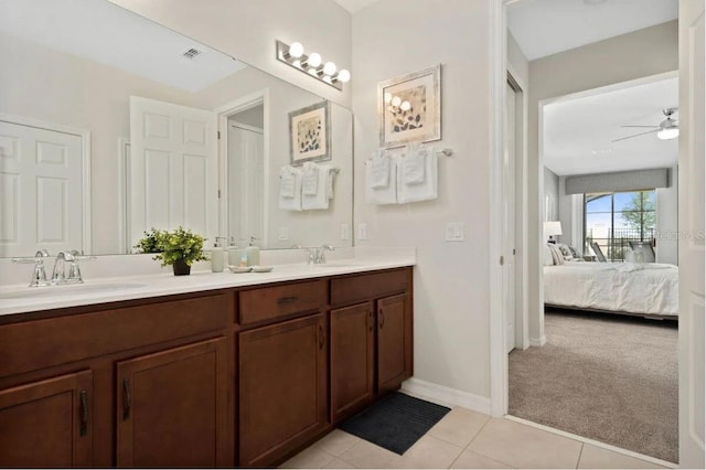 bathroom with tile patterned floors, double sink vanity, and ceiling fan