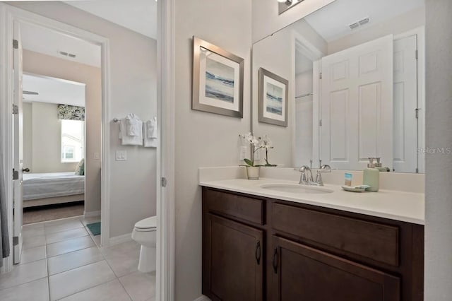 bathroom with vanity, tile patterned floors, and toilet