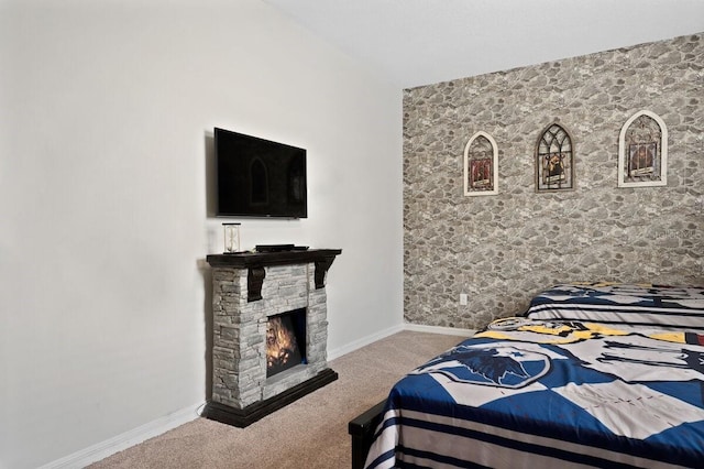 bedroom with a fireplace and carpet floors