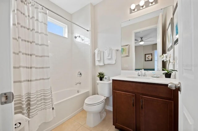 full bathroom with shower / bathtub combination with curtain, tile patterned floors, toilet, vanity, and ceiling fan